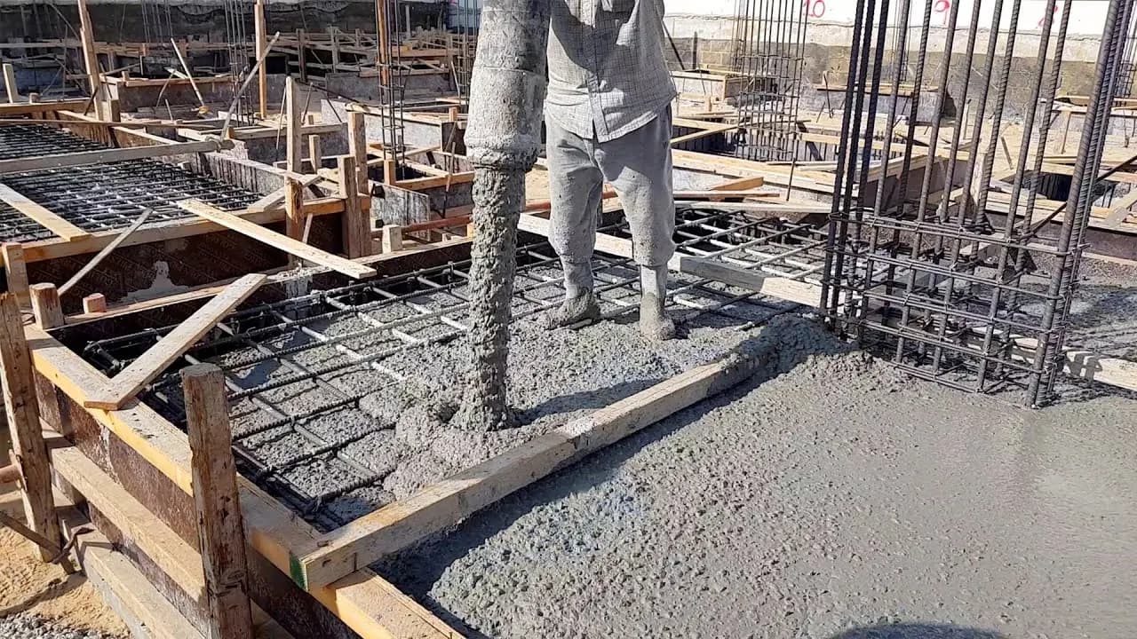 Concrete being poured into reinforced formwork at an active construction site